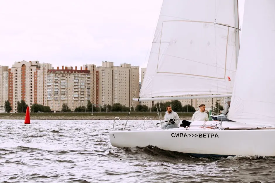 Yacht sailing with crew near city waterfront, showcasing nautical lifestyle.