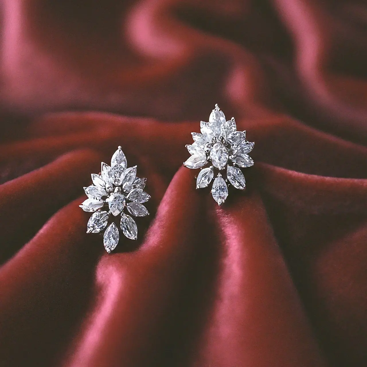 Sparkling cultured diamond earrings on a luxurious velvet background. 35mm stock photo