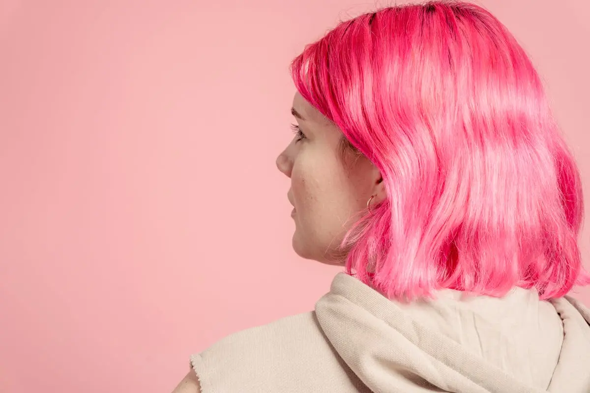 Unrecognizable woman with pink hair in studio