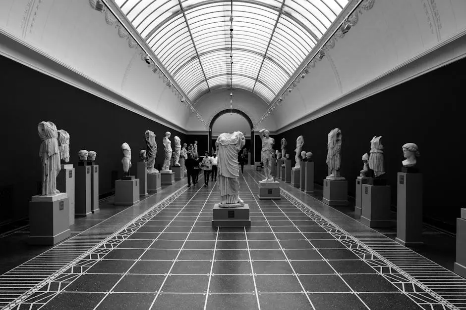 A captivating black and white view of sculptures in a Copenhagen museum hallway.