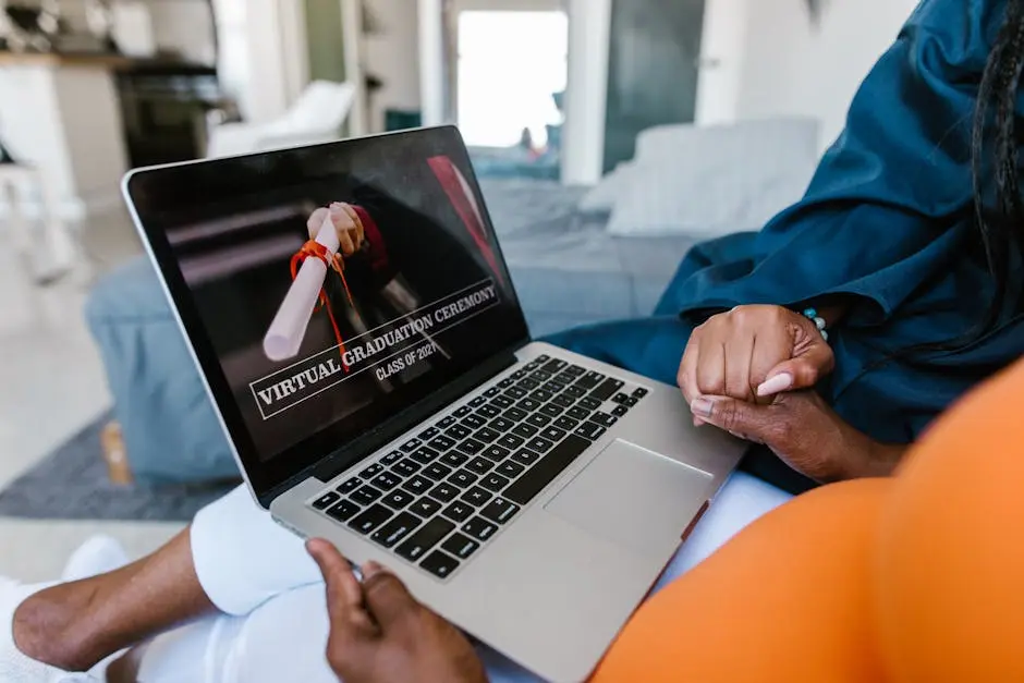 A virtual graduation ceremony on a laptop with a person in a graduation gown.