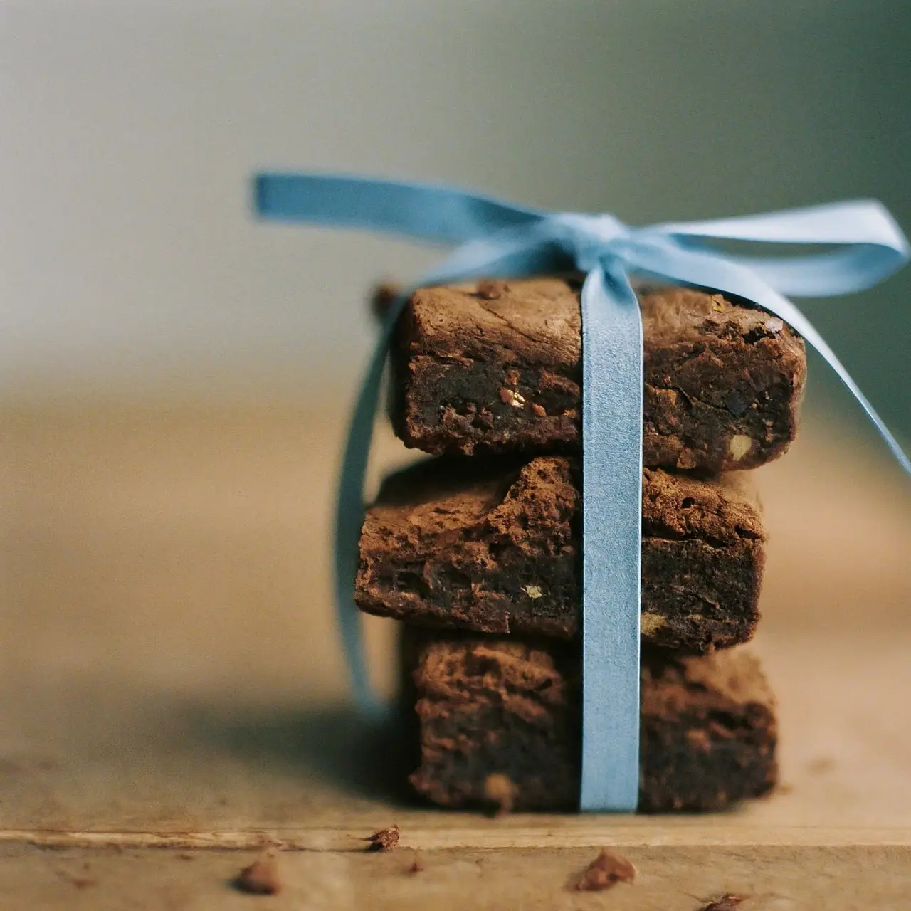 A stack of delicious brownies tied with a blue ribbon. 35mm stock photo