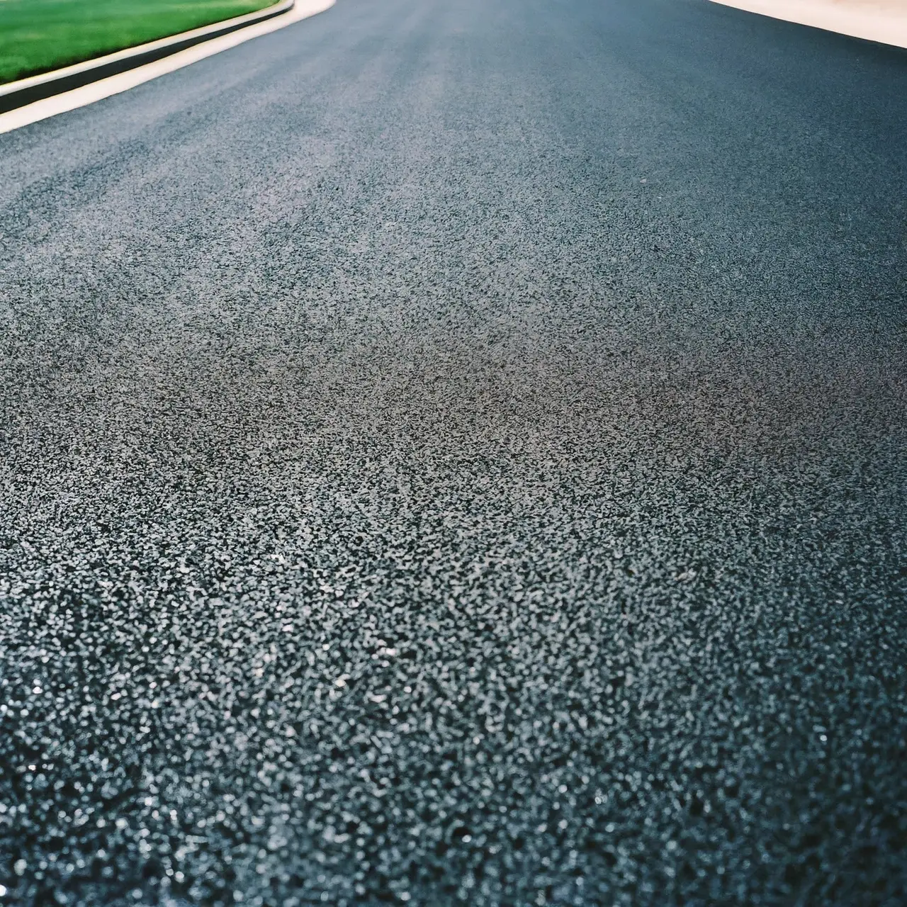 Close-up of a sleek, freshly paved asphalt driveway. 35mm stock photo