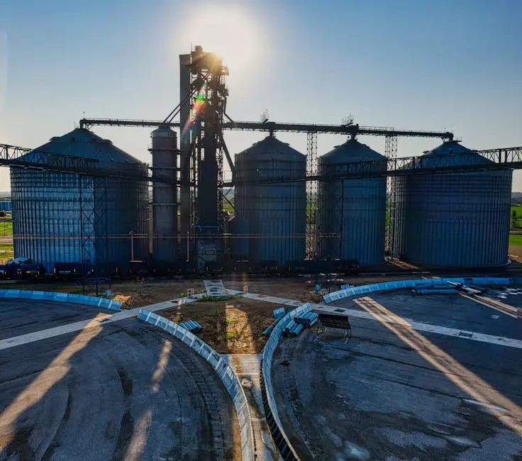 Aerial view of large industrial silos with the sun shining brightly in Randolph, MN.