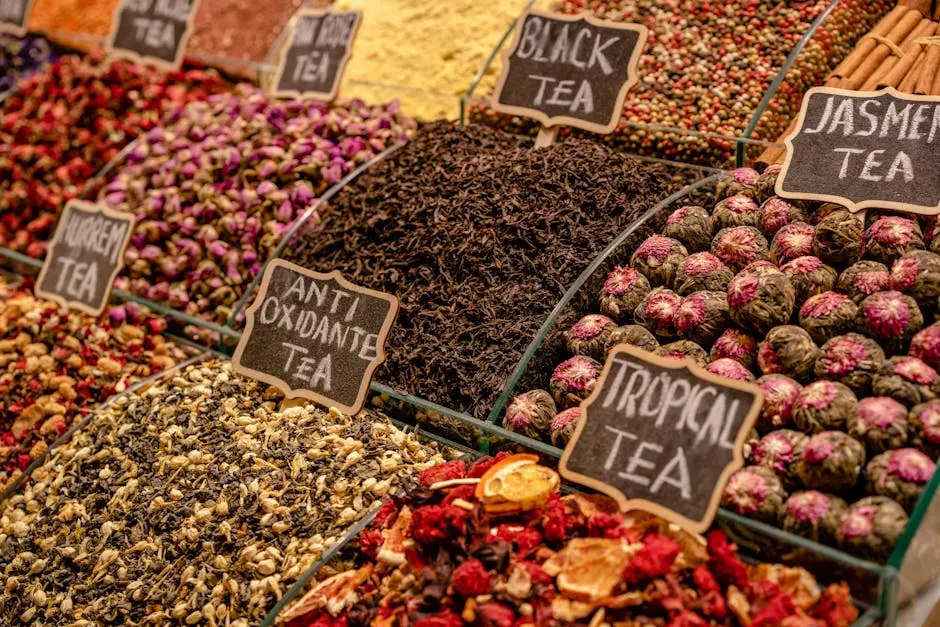 A vibrant display of various teas at a market stall, highlighting diverse flavors and colors.