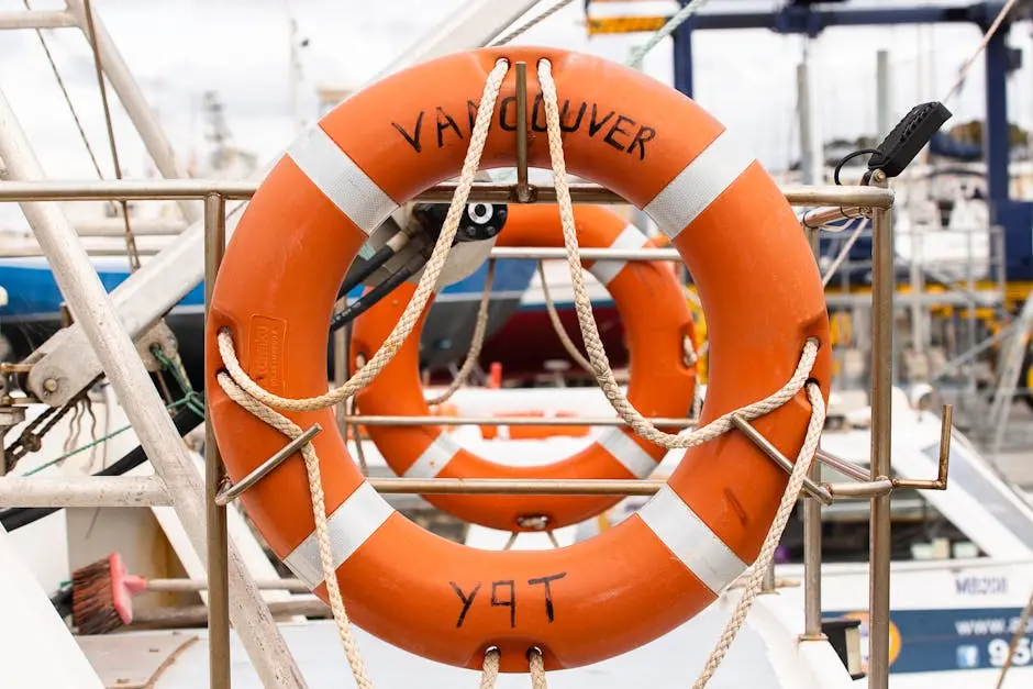 Orange Lifebuoy on a Silver Metal Fence