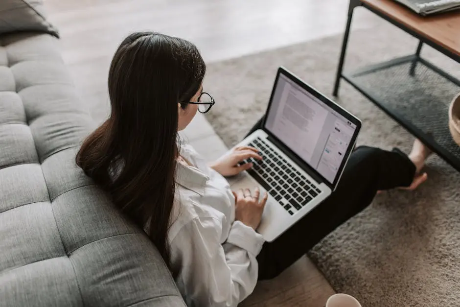 Woman Working At Home Using Her Laptop