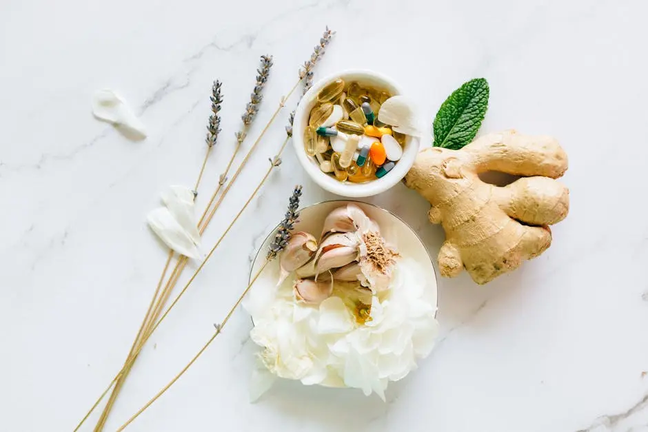 Flat lay of ginger, garlic, flowers, and supplements for holistic health.