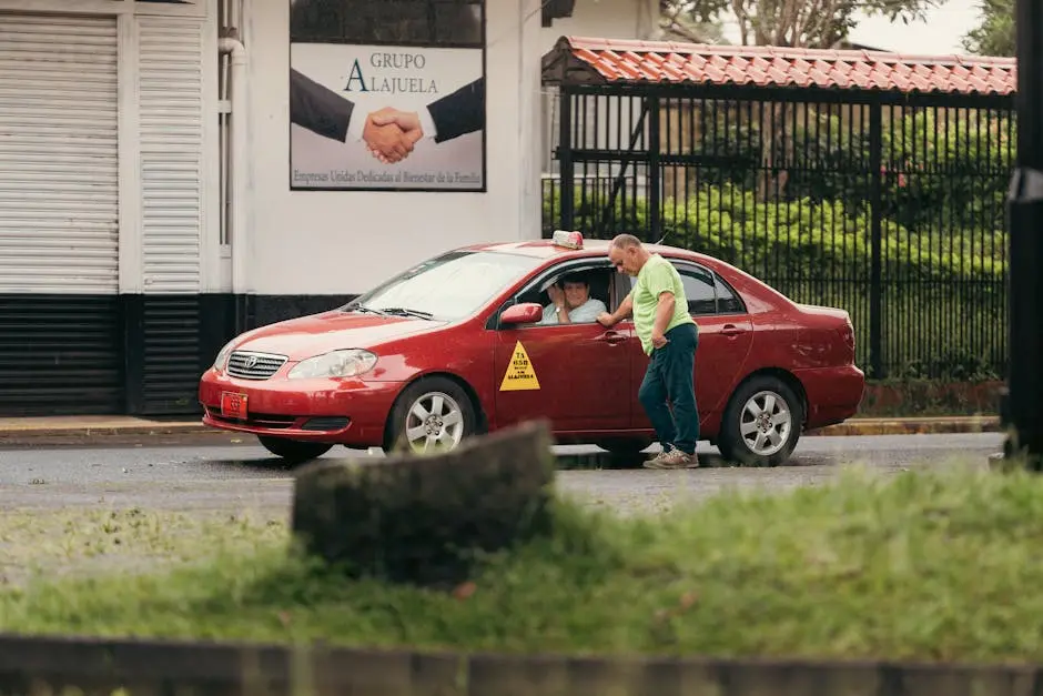 Two people interacting outside a red taxi on a rainy street in Alajuela, Costa Rica.