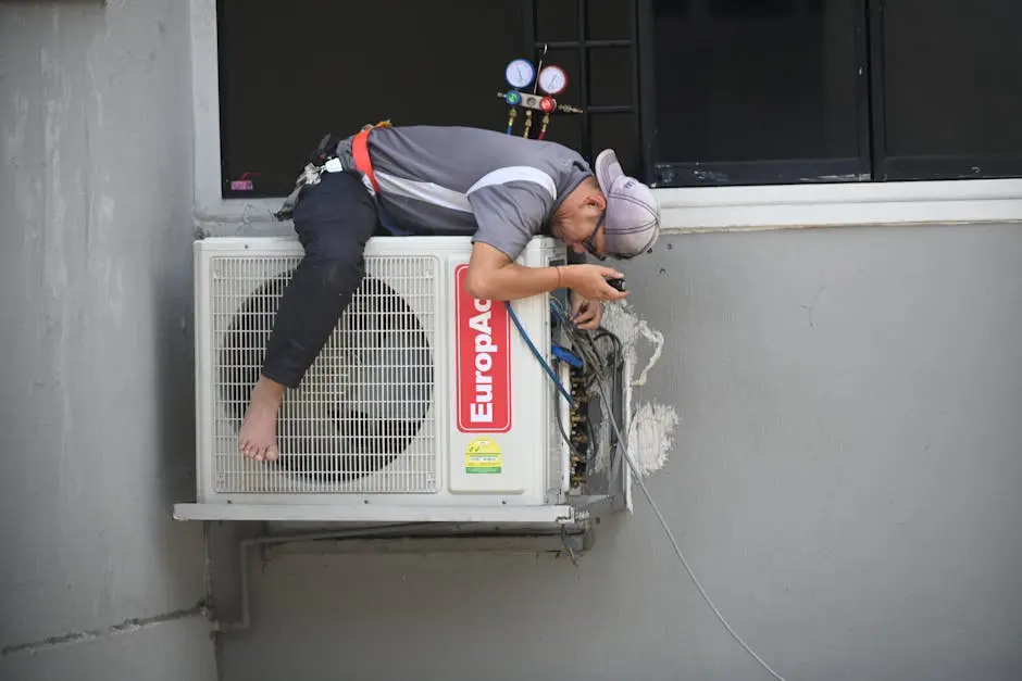 A technician skillfully repairing an outdoor air conditioning unit mounted on a building wall.