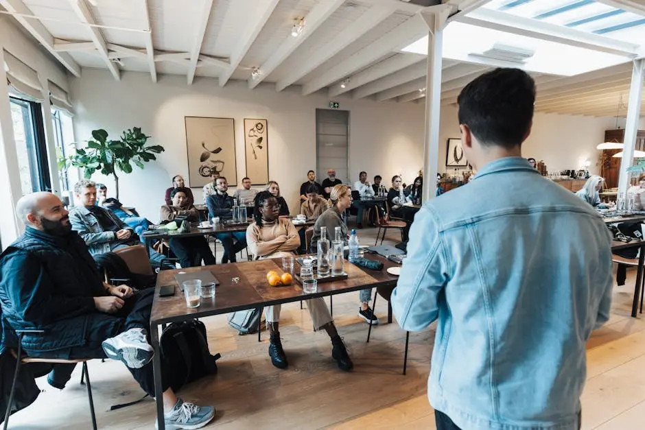 A diverse group attending a business presentation in a modern, well-lit conference room.