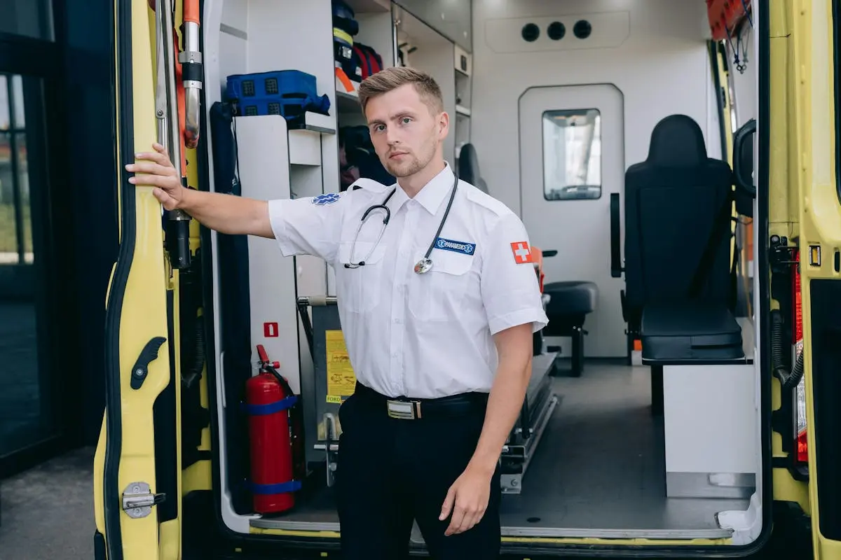 Paramedics with Stethoscope at the Barn Doors of the Ambulance