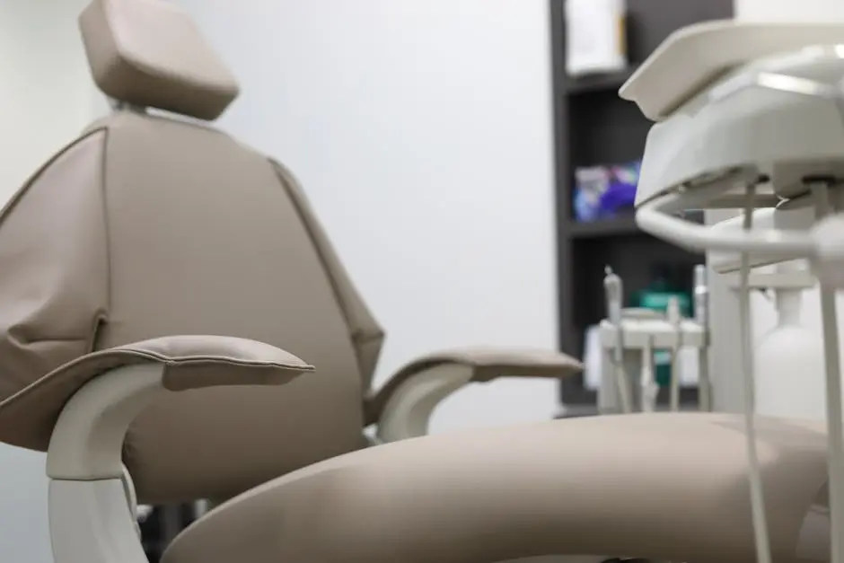 Close-up of dental chair and equipment in a clinical setting, emphasizing healthcare technology.