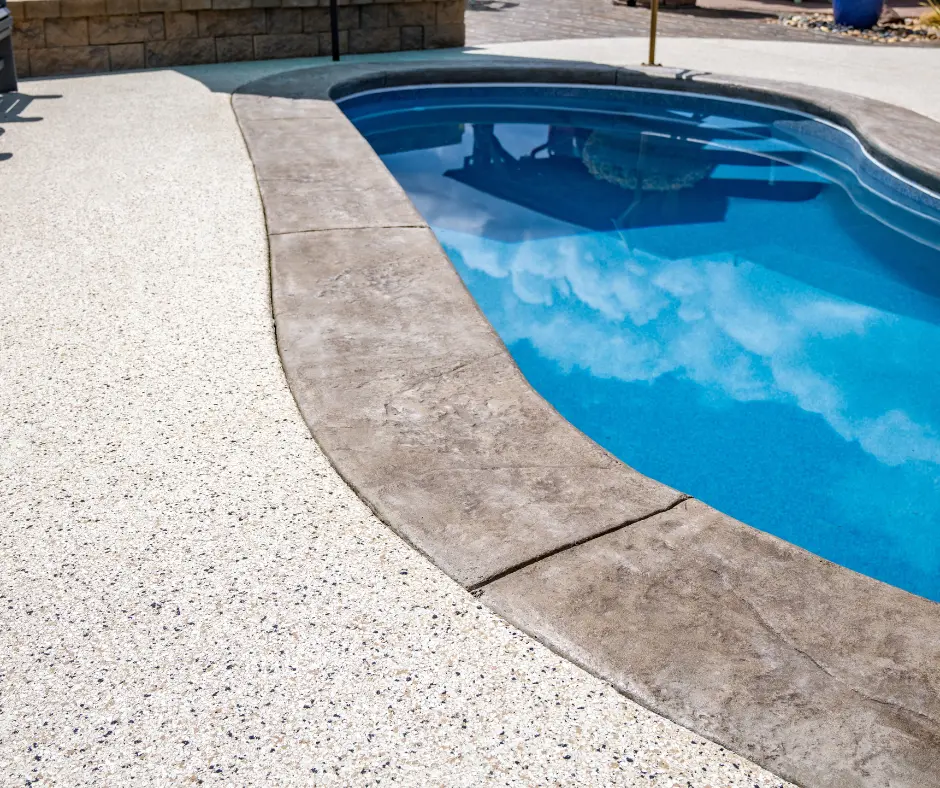 A pool deck featuring Elite Coatings Penntek flakes, showcasing a textured, slip-resistant surface with a blend of vibrant colors, enhancing both safety and visual appeal.