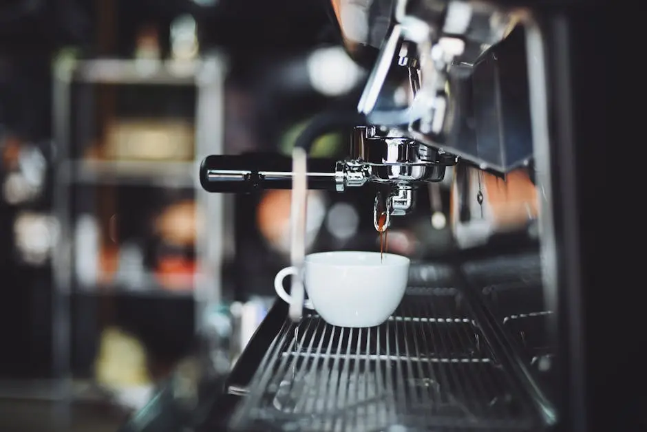 Espresso shot pouring into a cup from a coffee machine in a cafe setting.