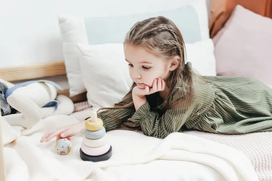 Adorable child enjoying playtime with toys in a comfortable bedroom setting.