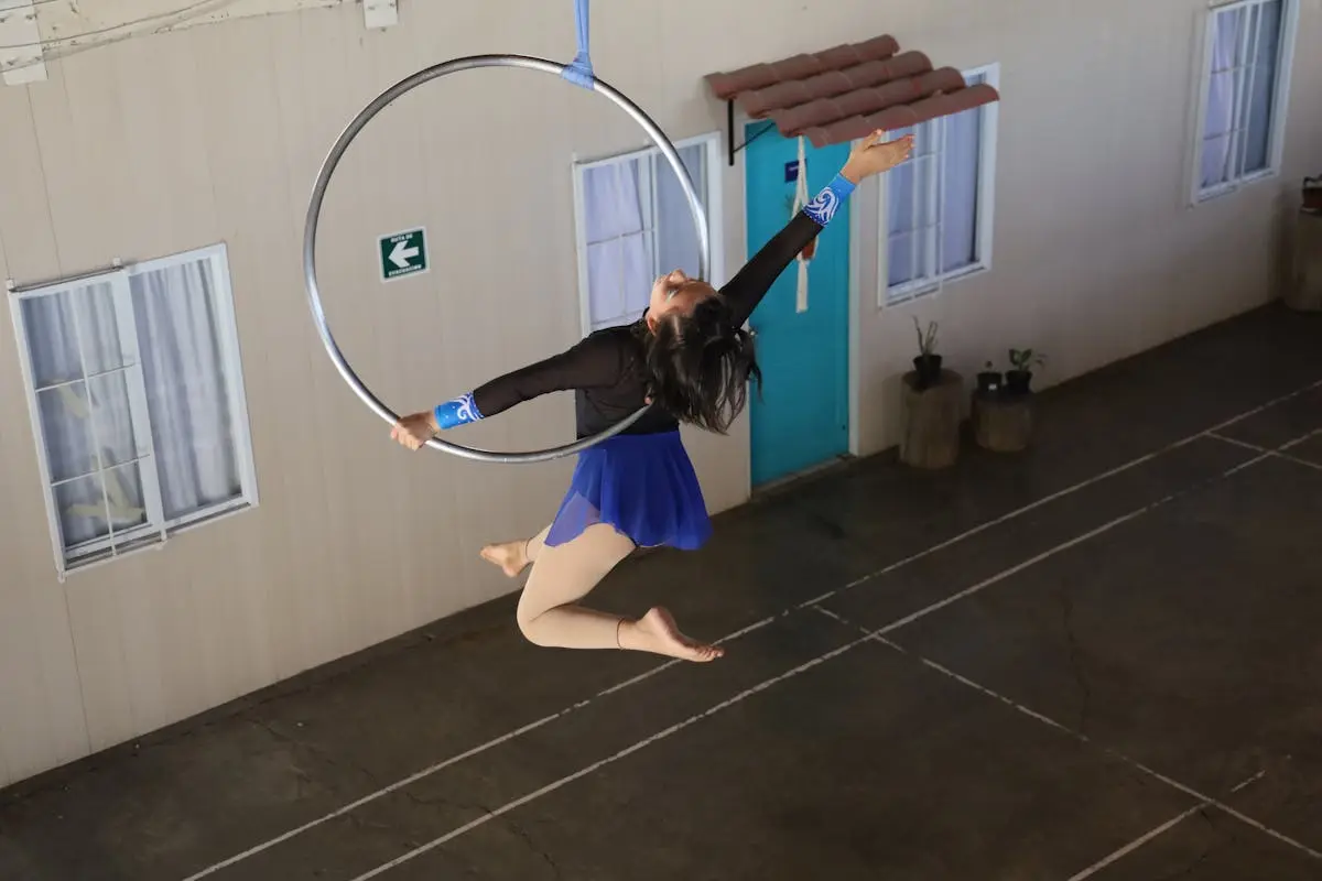 Girl Wearing Blue Skirt Performing on a Hula Hoop