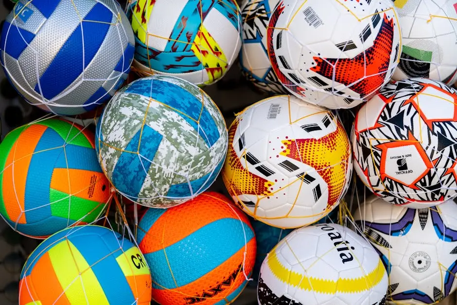 A close up of a pile of soccer balls