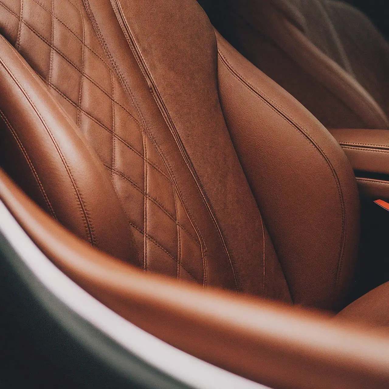 Close-up of leather conditioner on a luxury car seat. 35mm stock photo