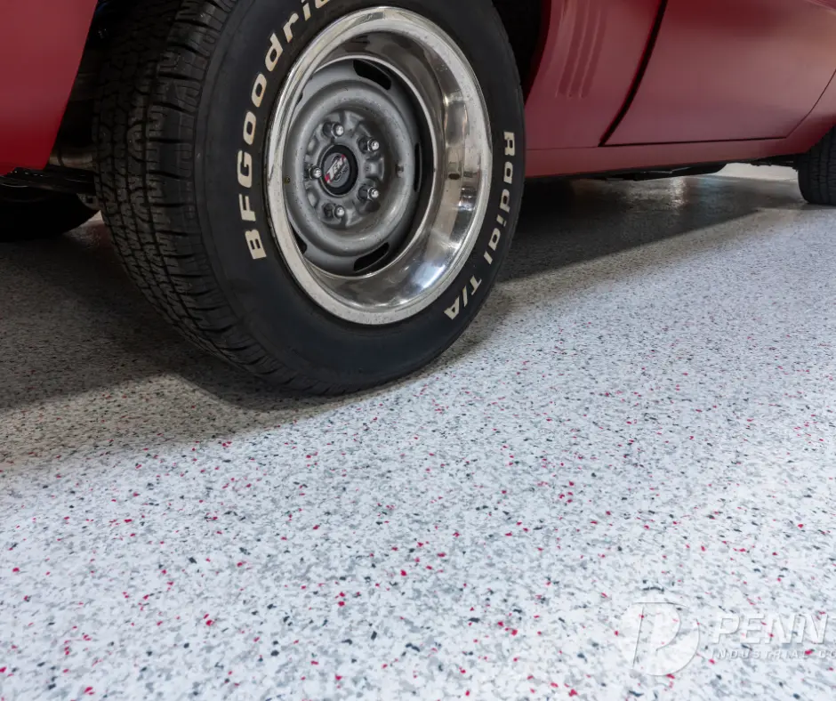 A car parked on an Elite Concrete Coating floor, showcasing the floor's sleek, polished finish and durable, high-quality surface.