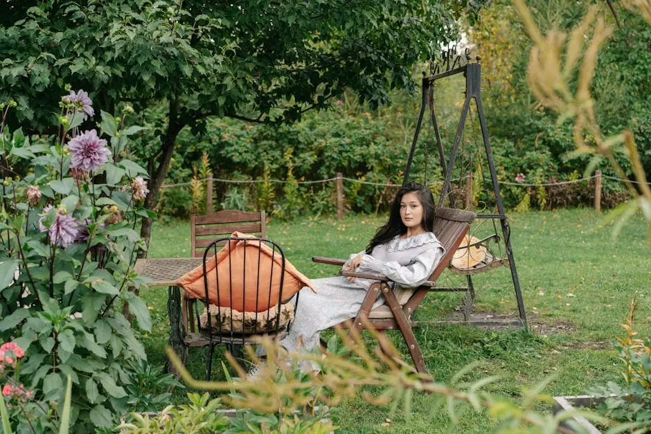 A woman lounging in a garden surrounded by lush greenery and colorful flowers.