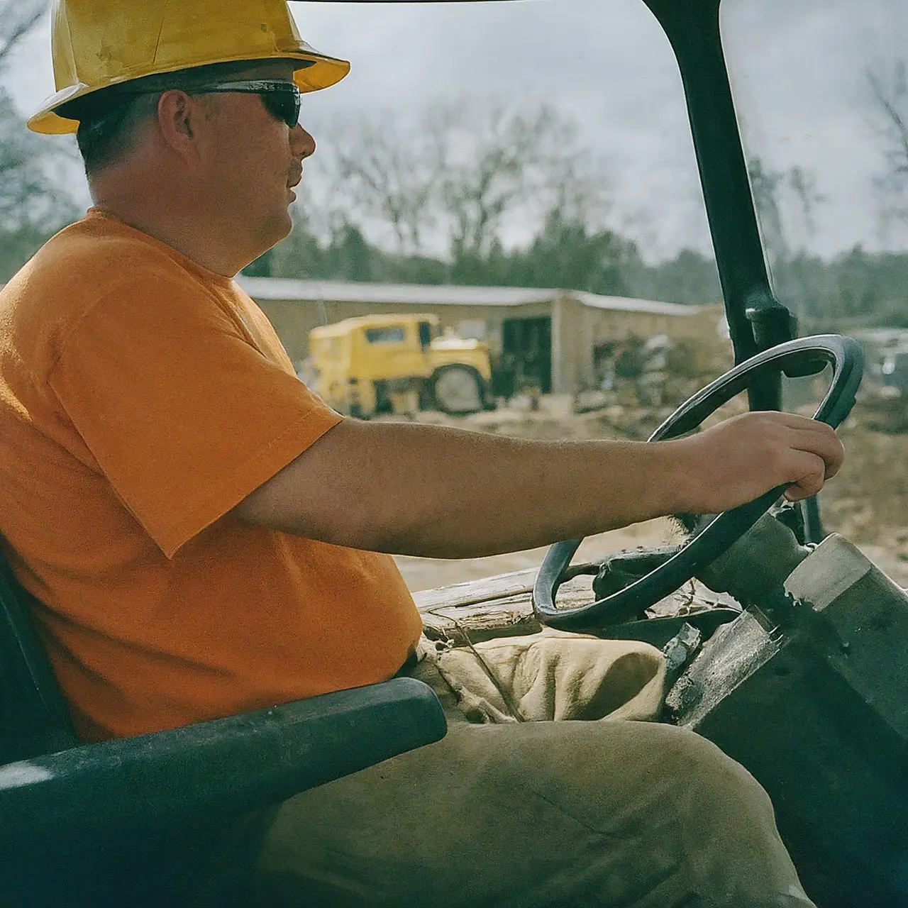 A construction worker operating rented heavy machinery on a job site. 35mm stock photo