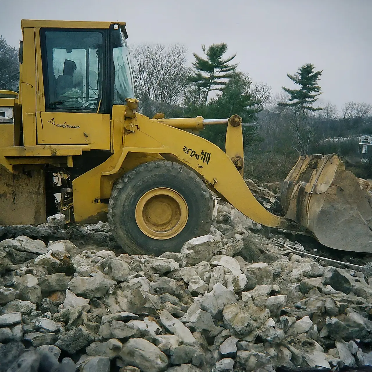 A construction worker clearing rubble with heavy machinery in Massachusetts. 35mm stock photo