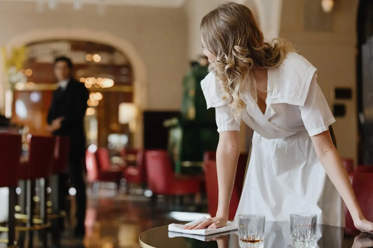 Woman in White Dress Leaning at work showing off how she can use style and safety with a pistol purse.