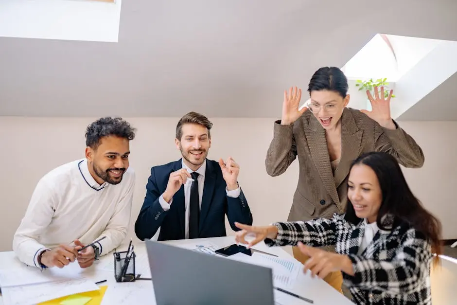 Happy diverse team of colleagues celebrating success in a modern office setting.