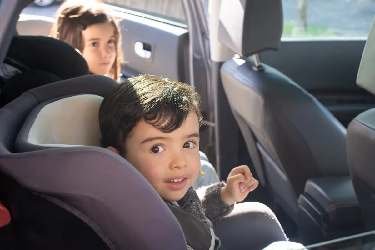 Two children sitting in a car, enjoying a family ride in Portugal.