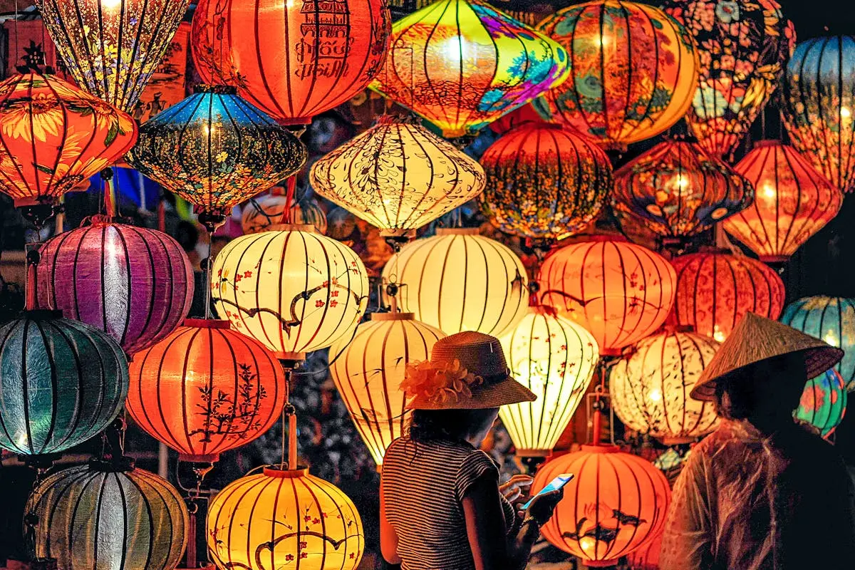 Two Person Standing Near Assorted-color Paper Lanterns