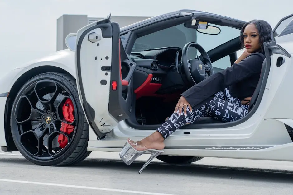 Fashionable African American woman in high heels sitting in a Lamborghini Huracan.