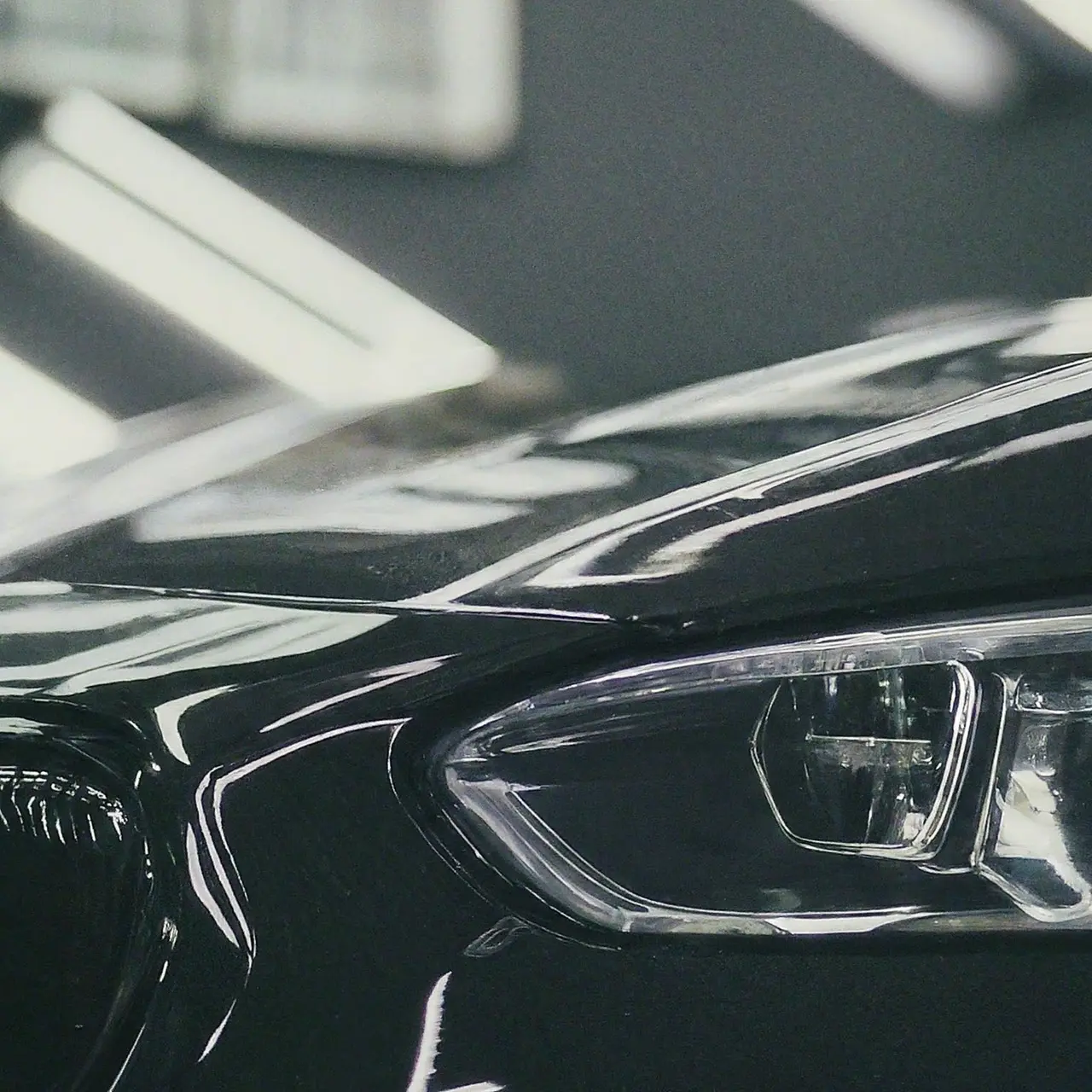 A sleek, shiny car reflecting sunlight after glass coating application. 35mm stock photo