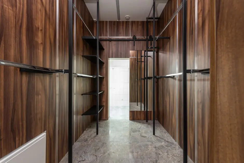 Spacious and modern walk-in closet with wooden paneling and sleek storage solutions.