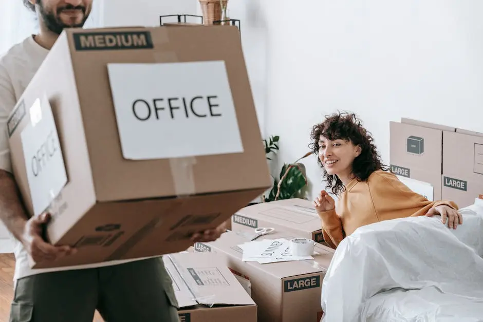 Man Carrying A Box Of Office Materials