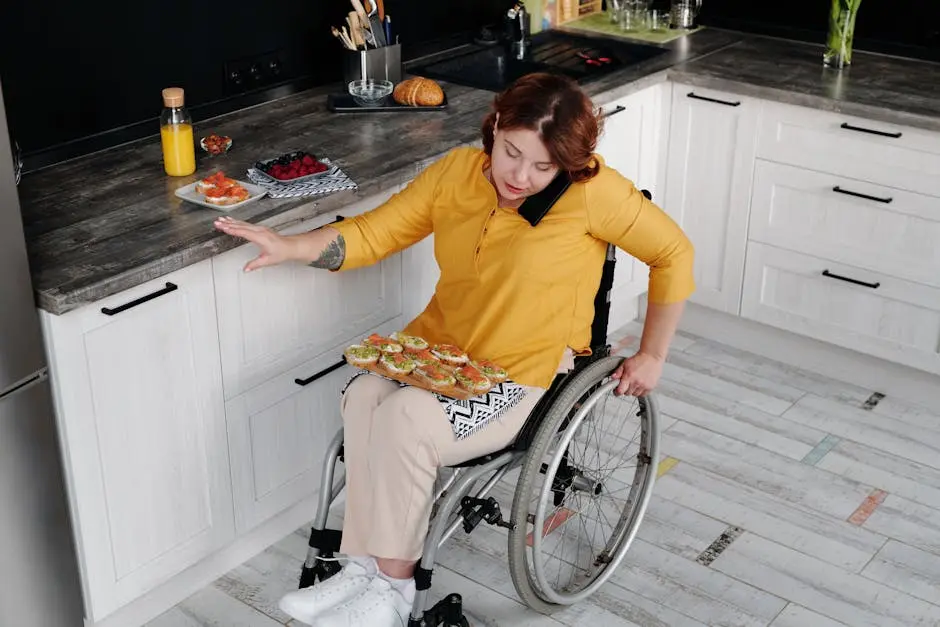 A woman in a wheelchair prepares food in a contemporary kitchen, showcasing everyday independence.