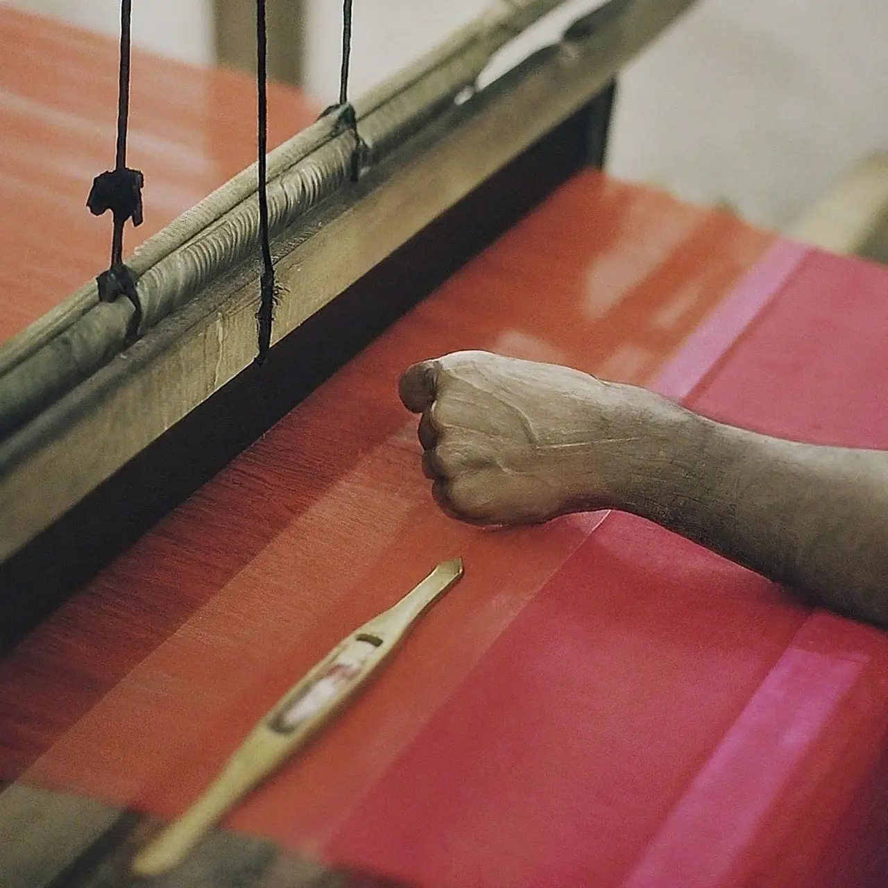 A skilled artisan weaving a Tant saree on a traditional loom. 35mm stock photo