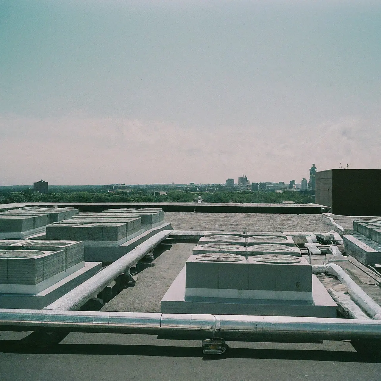 Rows of commercial HVAC systems on a building rooftop. 35mm stock photo