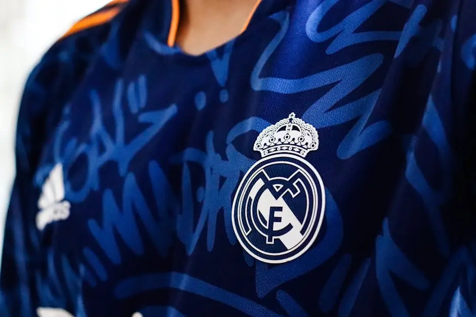 Detailed view of a blue soccer jersey featuring a prominent club emblem, ideal for sports branding.