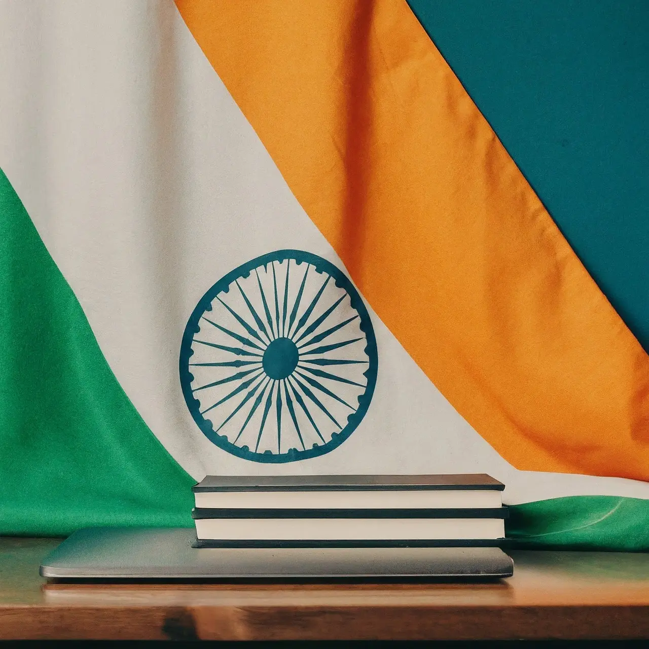 Laptop and books on a desk with the Indian flag. 35mm stock photo