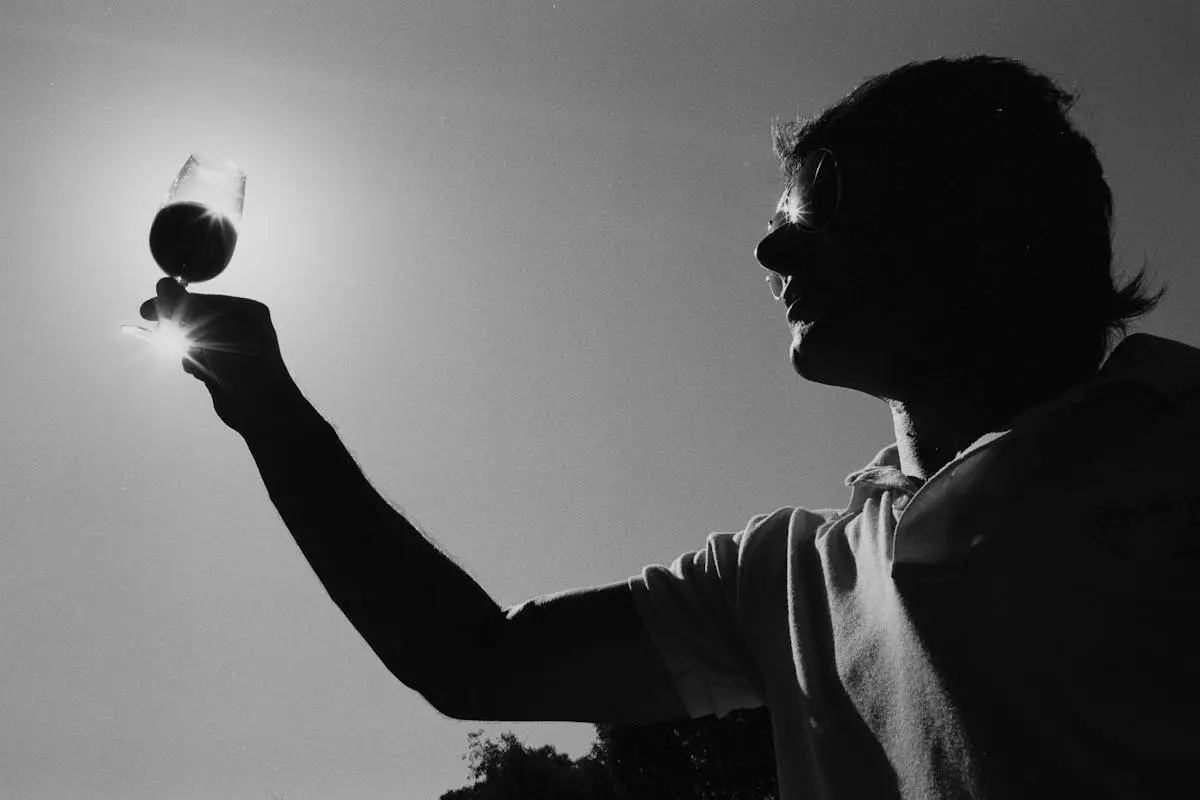 Low Angle Shot of Person holding a Wine Glass 