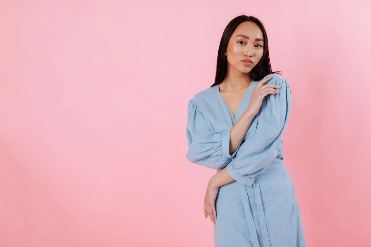 Woman in Blue Dress Posing with a hidden pistol