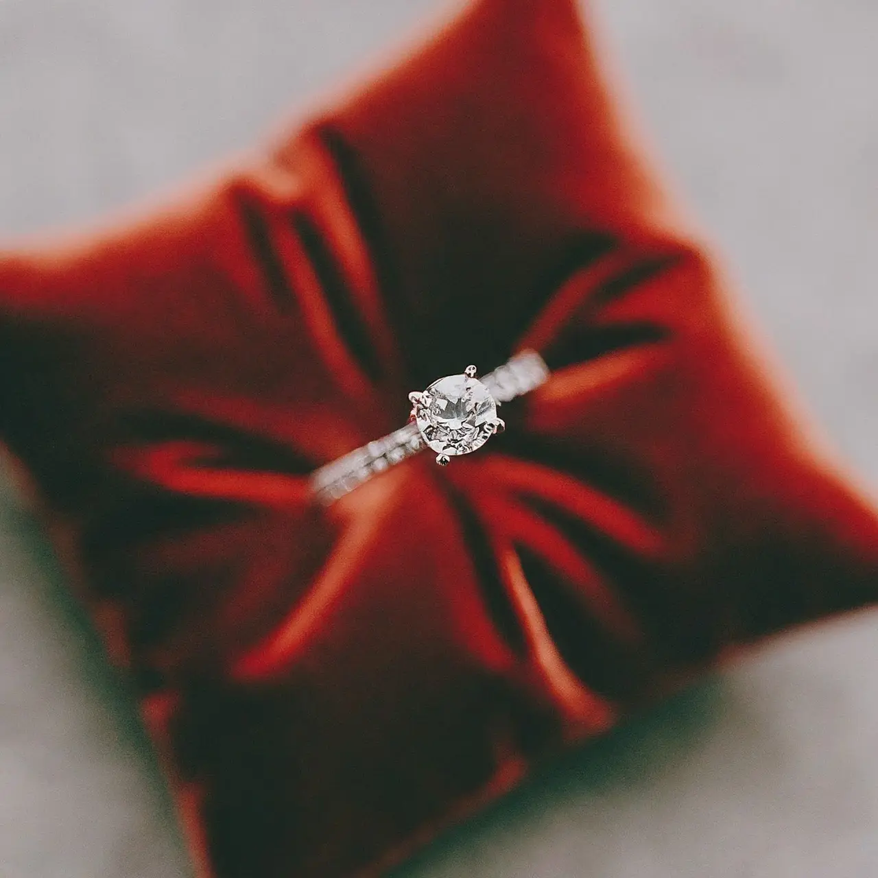 A diamond wedding band on a luxurious velvet cushion. 35mm stock photo