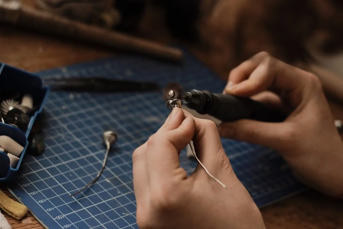 A Person Polishing a Silver Metal Piece