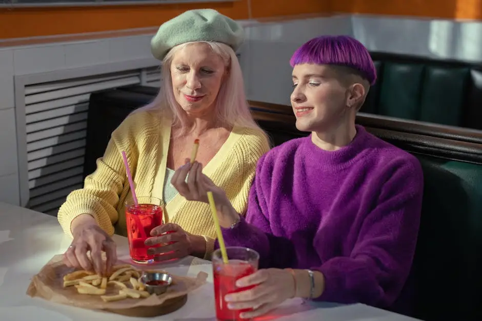 A joyful moment as mother and daughter share a meal with fries and drinks.