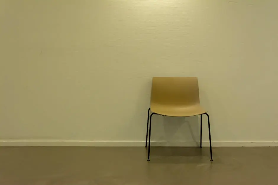 A chair in a room with a white wall