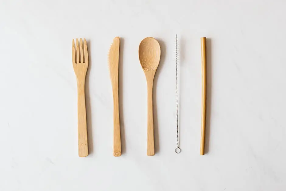 Wooden cutlery and tube with brush on marble table