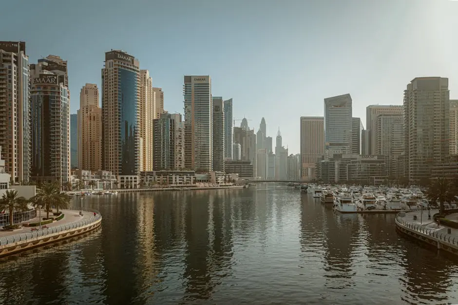 Stunning view of Dubai Marina featuring skyscrapers and calm reflective waters under a clear sky.