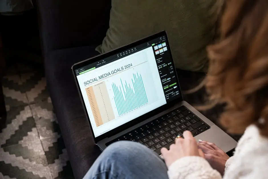 A woman reviewing 2024 social media goals on a laptop at home.