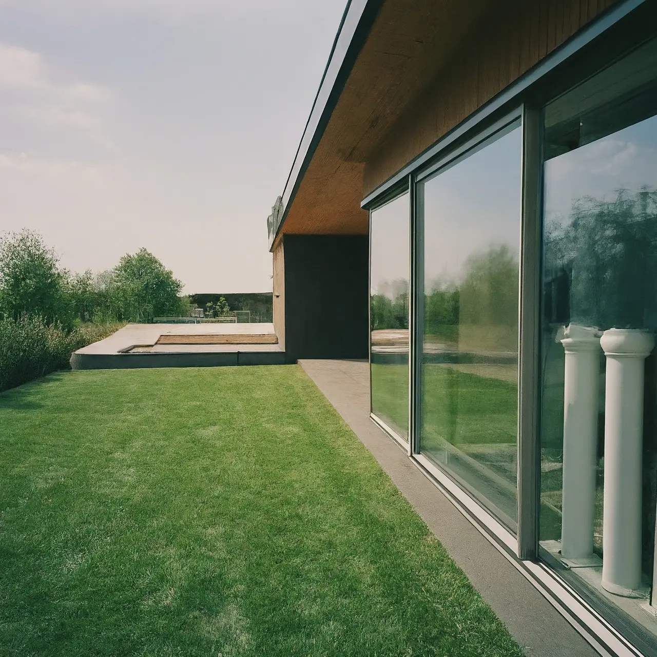 A modern home showcasing rainwater harvesting system components. 35mm stock photo